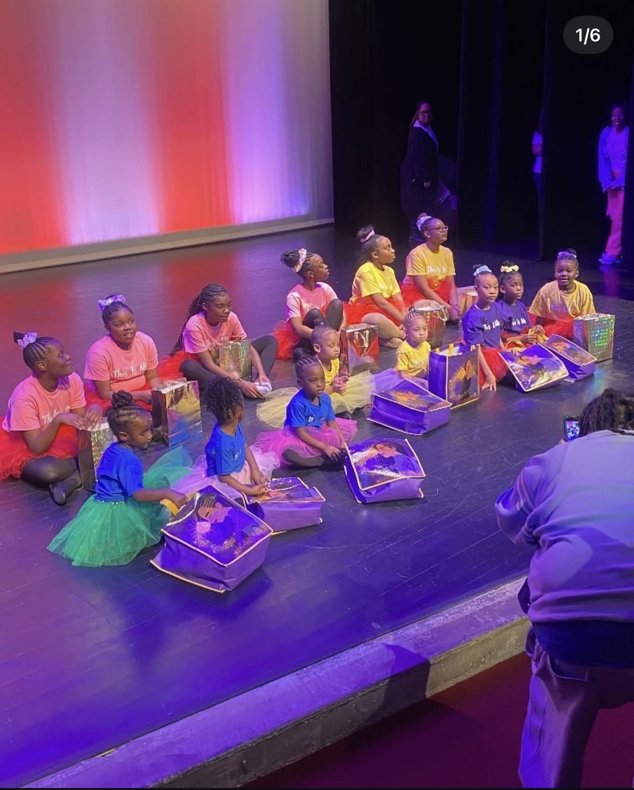 Dancers on stage with gift bags