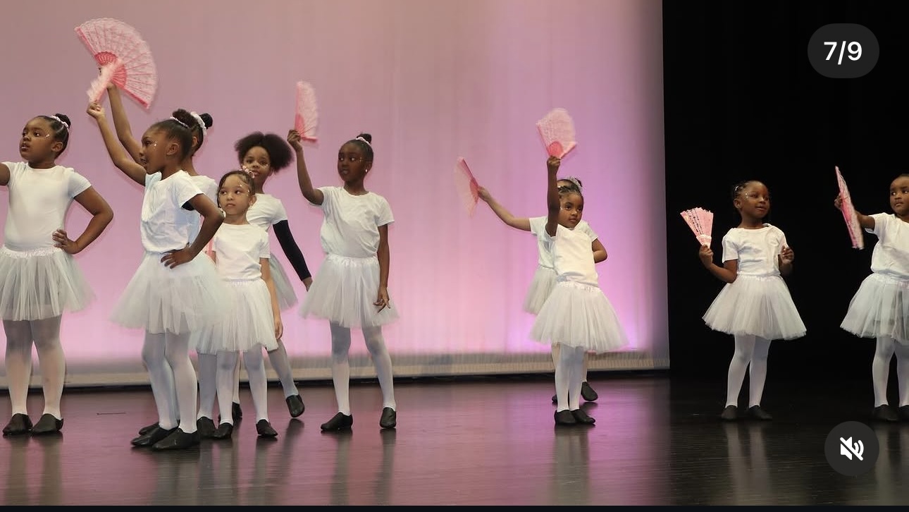 Young dancers performing with pink fans